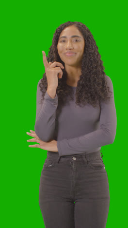 Vertical-Video-Three-Quarter-Length-Vertical-Video-Portrait-Of-Vertical-Video-Woman-Being-Inspired-By-Good-Idea-Against-Green-Screen-At-Camera